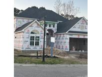 New construction home featuring modern design elements and a spacious two-car garage at 5508 Via Verde Dr., North Myrtle Beach, SC 29582