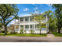 Charming two-story home boasts a spacious double porch, perfect for relaxing and enjoying the neighborhood views at 231 Screven St., Georgetown, SC 29440