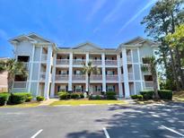 Beautiful three-story condo building with white columns, balconies and manicured landscaping at 606 Waterway Village Blvd. # 28-C, Myrtle Beach, SC 29579