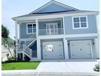 Beautiful two-story coastal home featuring a double garage, balcony, and charming white trim at 2307 Tortuga Ln., North Myrtle Beach, SC 29582