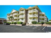 Beautiful condo complex with multiple balconies and lush green landscaping near parking lot at 2805 N Ocean Blvd. # 113, Myrtle Beach, SC 29577