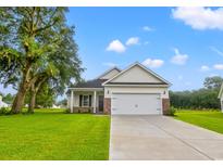 One-story house with a white two-car garage and nicely landscaped lawn at 85 Millsite Ct., Georgetown, SC 29440