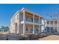 Charming multi-story home with brick facade and a welcoming double-decker porch, perfect for enjoying outdoor living at 835 Crescent Sable Ct., Myrtle Beach, SC 29572