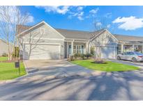 Two-story home with attached garage and landscaped lawn at 103 Palmetto Green Dr. # 103, Longs, SC 29568