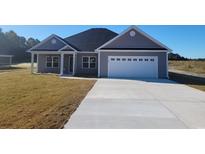 Charming gray home with a two-car garage, concrete driveway, and a well-maintained lawn at Tbd 7 Privetts Rd., Conway, SC 29526