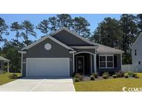 Charming single-story home with a well-maintained lawn and a two-car garage in a suburban neighborhood at 129 Fair Meadow Ct., Loris, SC 29569