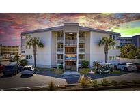 Beautiful condo complex with palm trees, multiple levels, and ample parking with a peek at the sunset in the background at 9600 Shore Dr. # A-102, Myrtle Beach, SC 29572