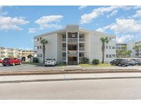 Exterior view of a beach condo building with parking and landscaping at 9600 Shore Dr. # A-102, Myrtle Beach, SC 29572