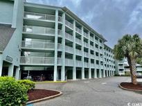 Eastport building featuring bike racks with a green and well maintained landscape at 14290 Ocean Highway # 111, Pawleys Island, SC 29585