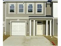 Charming townhome featuring a one-car garage and a covered front porch at 293 Sandridgebury Dr. # 66, Little River, SC 29566