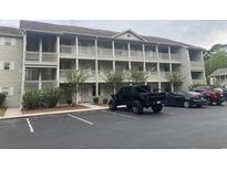 Two-story condo building with ample parking and surrounding trees at 1230 St. George Ln. # B, Myrtle Beach, SC 29588