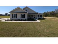 Charming one-story home with manicured lawn and inviting front porch at Tbd 16 Privetts Rd., Conway, SC 29526