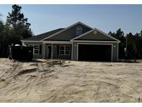 Charming single-story home with a two-car garage and well-lit exterior at Tbd 18 Privetts Rd., Conway, SC 29526