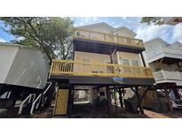 Charming beach house with multiple decks and outdoor access under the raised structure at 6001 South Kings Hwy., Myrtle Beach, SC 29575