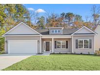 New construction home with gray siding, two-car garage, and a well-manicured lawn at 4414 Kinlaw St., Little River, SC 29566