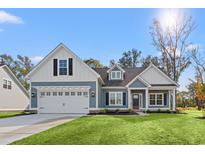 Charming single-Gathering home with blue siding, white trim, and a well-manicured front lawn at 639 Carter Reid Ct., Longs, SC 29568