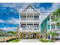 Stunning elevated beach house with multiple balconies, offering ocean views and coastal charm at 113A 12Th Ave. S, Surfside Beach, SC 29575