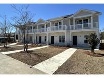 Charming townhomes feature private balconies, stone accents, and well-manicured landscaping at 821 Rebecca Ln. # 6C, Myrtle Beach, SC 29577