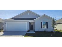 Charming single-story home with a two-car garage and manicured lawn at 3858 Lady Bug Dr., Shallotte, NC 28470