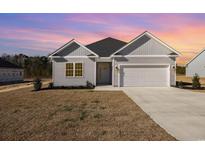Newly constructed home with gray siding, white trim, and a two-car garage at 369 Log Cabin Rd., Loris, SC 29569