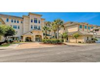 Beautiful condominium building entrance surrounded by mature landscaping and a circular driveway at 2180 Waterview Dr. # 721, North Myrtle Beach, SC 29582