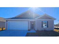 Charming one-story home with a two-car garage, neutral siding, and manicured landscaping at 3870 Lady Bug Dr., Shallotte, NC 28470
