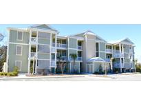 Green three-story apartment building with white accents and balconies at 81 Delray Dr. # 3-C, Murrells Inlet, SC 29576