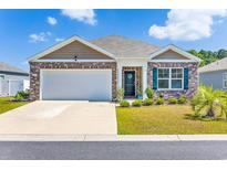 Brick home with attached garage, landscaping, and a welcoming front porch at 142 Pine Forest Dr., Conway, SC 29526