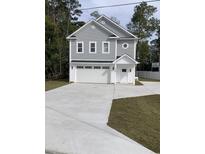 Charming two-story home with a gray exterior, white trim, an attached garage, and a concrete driveway at 1738 Cenith Dr., North Myrtle Beach, SC 29582