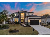 Stunning two-story home with a three-car garage and manicured lawn at 933 Bluffview Dr., Myrtle Beach, SC 29579