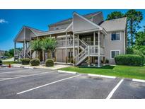 Inviting condominium with landscaped grounds, ample parking, and classic wood staircase at 1095 W Plantation Dr. W # 28D, Little River, SC 29566