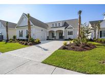 Two-story home with gray siding, brick accents, and palm trees at 6850 Belancino Blvd., Myrtle Beach, SC 29579