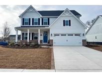 Two-story house with white siding, blue door, and attached garage at 2301 Hazel Way, Longs, SC 29568