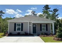 Charming single-story home showcasing a well-manicured lawn and a welcoming front entrance at 116 Arbor Crest Ln., Tabor City, NC 28463