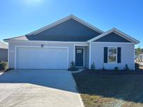 Newly constructed home with gray siding, white garage door, and landscaped lawn at 379 Black Pearl Way, Myrtle Beach, SC 29588