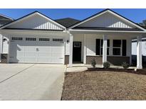 Newly constructed home with a two-car garage and attractive landscaping at 573 Beckham Ct., Murrells Inlet, SC 29576