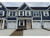 Charming new construction townhome with attached garages and craftsman style design on a cloudy day at 8928 Brynlee Rd. # 4B, Longs, SC 29568