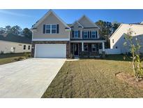 Charming two-story home with a stone and siding facade and attached two-car garage at 364 Clear Lake Dr., Conway, SC 29526