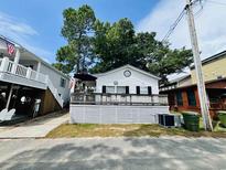 Charming single-story beach house with a spacious front porch and white picket fence at 6001 - 1795 S Kings Hwy., Myrtle Beach, SC 29575