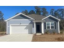 Two-toned blue house with a white garage door and landscaping at 136 Pampa Dr., Loris, SC 29569