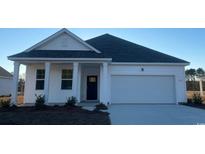 White house with gray roof, attached garage, and landscaping at 145 Pampa Dr., Loris, SC 29569