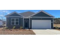 Gray house with white garage door and landscaping at 149 Pampa Dr., Loris, SC 29569