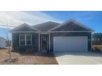 Gray house with white garage door and landscaping at 149 Pampa Dr., Loris, SC 29569