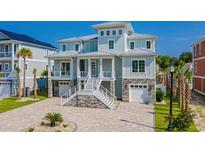 Two-story waterfront home with stone accents and expansive windows at 129 Serenity Point Dr., Little River, SC 29566