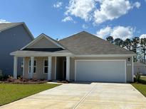 Charming single-story home features a two-car garage and well-maintained landscaping at 62 Arbor Crest Ln., Tabor City, NC 28463