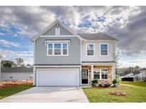 Charming two-story home featuring a two-car garage and a well-manicured lawn at 126 Hancher Dr., Myrtle Beach, SC 29588