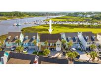 Beautiful elevated home with a deck overlooking a tranquil waterway and marina in a coastal community at 4524 Landing Rd., Little River, SC 29566
