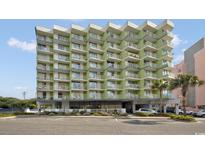 Modern condo building with balconies and beautiful landscaping in a popular vacation destination at 7000 Ocean Blvd. N # 133, Myrtle Beach, SC 29572