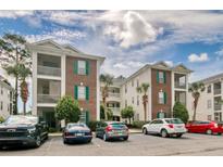 Brick building with balconies, parking, and palm trees at 500 River Oaks Dr. # 58I, Myrtle Beach, SC 29579