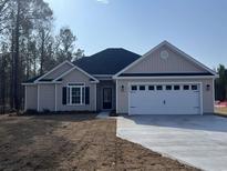 Charming single-story home with a two-car garage and a well-manicured front yard at 1033 Sioux Swamp Dr., Conway, SC 29527